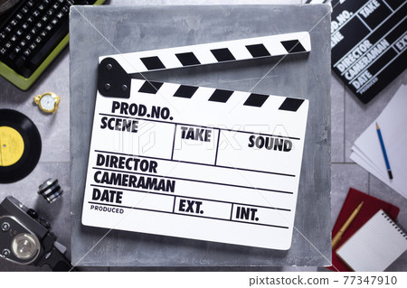 Movie clapboard or  clapper at old table. Clapperboard and screenwriter or movie writer concept 77347910