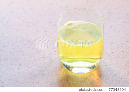 water with yellow effervescent tablet of vitamin water with yellow effervescent tablet of vitamin 77348304