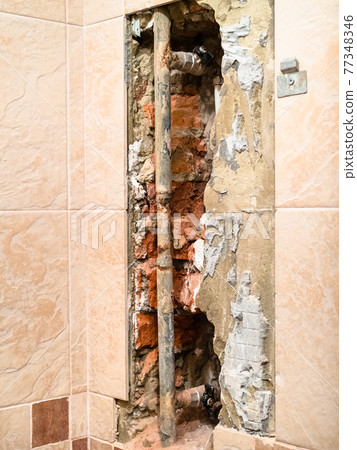 water supply pipe in hole in wall covered by tiles water supply pipe in hole in wall covered by tiles 77348346