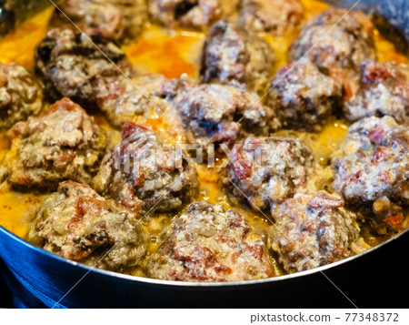 meatballs are stewed in saucepan close up 77348372