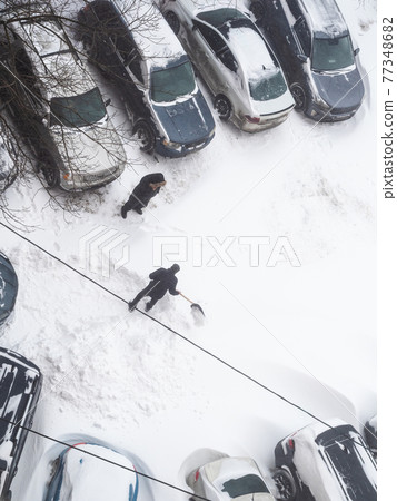 drivers clear snow drifts from parking area drivers clear snow drifts from parking area 77348682