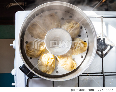 top view of homemade manti are cooking in steamer 77348827