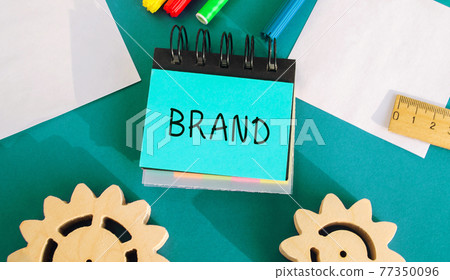 Notes with inscription Brand. Business, marketing, and advertising. Name, term, design, symbol that identifies one seller's good or service. Gears, markers, ruler. Notes with inscription Brand. Business, marketing, and advertising. Name, term, design, symbol that identifies one seller's good or service. Gears, markers, ruler. 77350096
