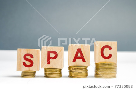 Wooden blocks with the word SPAC - Special purpose acquisition company. Simplified listing of company, merger bypassing stock exchange IPO. Assessment of benefits and risks of investments 77350098