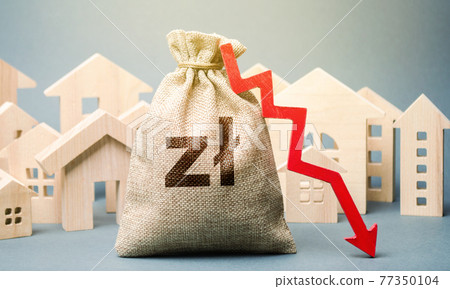 City residential buildings and polish zloty money bag with a red down arrow. The concept of low cost real estate. Lower mortgage interest rates. Falling prices for rental housing and apartments. 77350104