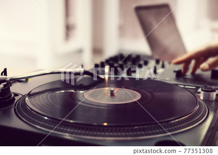 Dj playing record vinyl on turntable, no face 77351308
