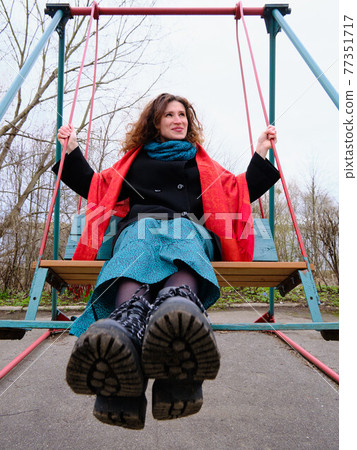 woman swinging on the swing woman swinging on the swing 77351717