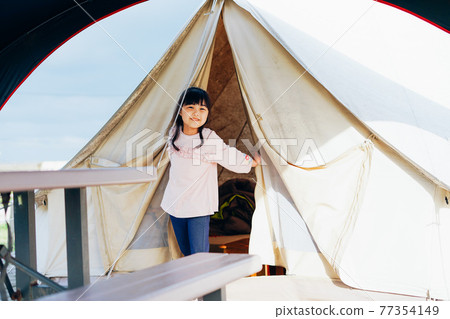 Little girl enjoying camping Little girl enjoying camping 77354149
