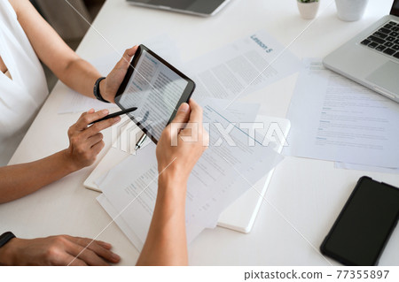 Young woman and man studying for a test or exam Tutor books with friends catching up and learning, education and school concept. 77355897
