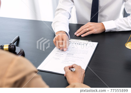 lawyer or judge meeting with client consulting help discussing contract paper agreement. 77355899