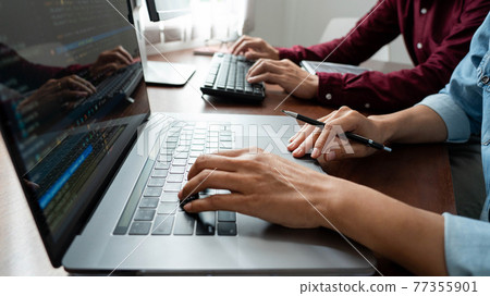 Team of Programmer working to find solution to problem and coding technologies in a software developing company office. Team of Programmer working to find solution to problem and coding technologies in a software developing company office. 77355901