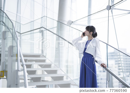 Woman using a smartphone Woman using a smartphone 77360590