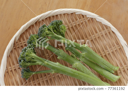 Stalk broccoli on a colander (Broccolini) 77361192