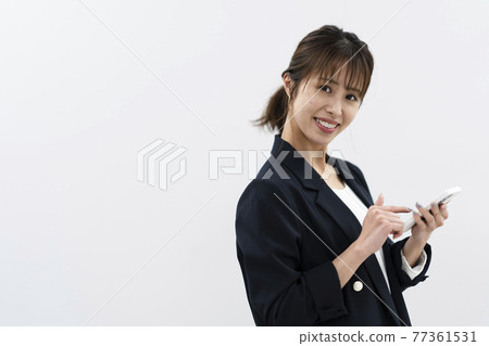 A woman using a mobile phone 77361531