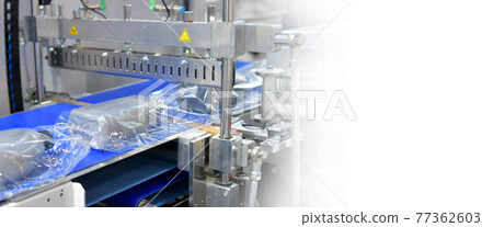 Modern machine for packaging products on conveyor belt in factory ,copy space Modern machine for packaging products on conveyor belt in factory ,copy space 77362603