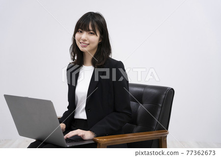 Woman using a laptop Woman using a laptop 77362673