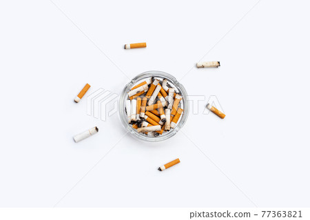 Smoked cigarettes on white background. Smoked cigarettes on white background. 77363821