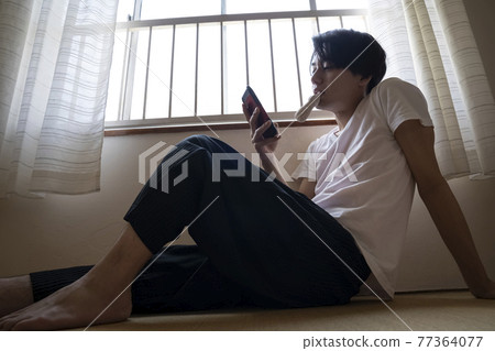 Man eating ice cream in the room 77364077