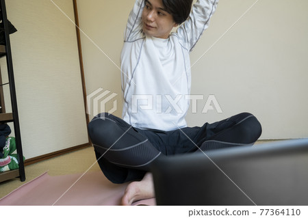Men stretching at home 77364110