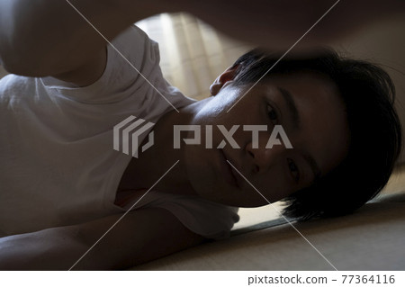 A man relaxing in the room A man relaxing in the room 77364116