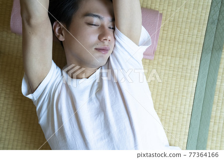 A man relaxing in the room A man relaxing in the room 77364166