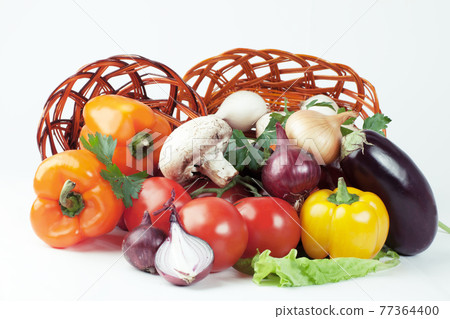 mushrooms and a variety of fresh vegetables in a wicker basket.i 77364400