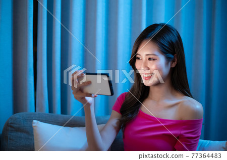 Woman look Smartphone Happily Woman look Smartphone Happily 77364483