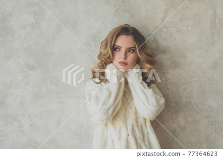 Nice blonde woman with healthy curly hair on gray background portrait 77364623