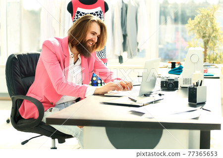 Concentrated man working on laptop and doing home design Concentrated man working on laptop and doing home design 77365653