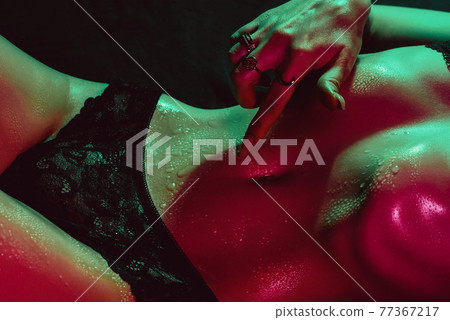 girl with a sexy body touches her tummy with her hand next to her panties. Female beautiful slender figure 77367217