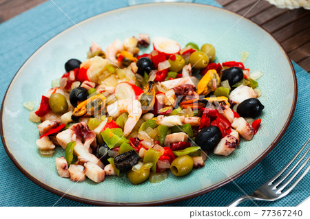 Popular Spanish Salpicon from vegetables and seafood mix 77367240