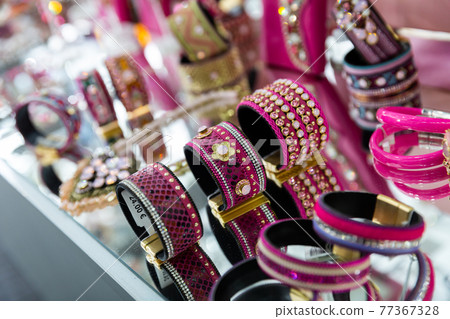 Various adornments on showcase in bijouterie shop Various adornments on showcase in bijouterie shop 77367328