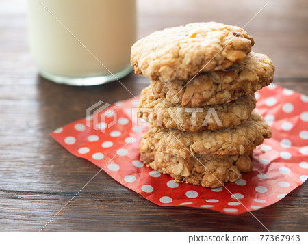 Oatmeal cookies and milk 77367943