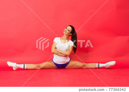 Beautiful young fit gymnast woman in sportswear working out, performing art gymnastics element Beautiful young fit gymnast woman in sportswear working out, performing art gymnastics element 77368342