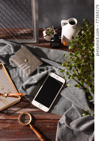 Cluttered table smartphone Cluttered table smartphone 77369279