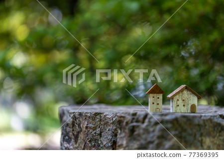 Two small cute wooden houses (fresh green background) Two small cute wooden houses (fresh green background) 77369395