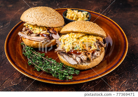 Pulled Pork meat Hamburger with coleslaw salad. Dark background. Top view Pulled Pork meat Hamburger with coleslaw salad. Dark background. Top view 77369471