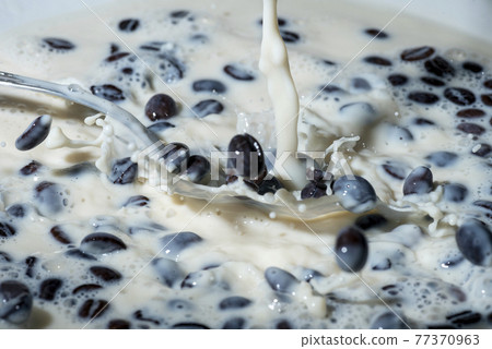 Coffee beans falling on the milk splash. Coffee beans falling on the milk splash. 77370963