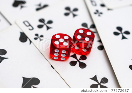 Dice on cards in a casino with a drawn nine Dice on cards in a casino with a drawn nine 77372687