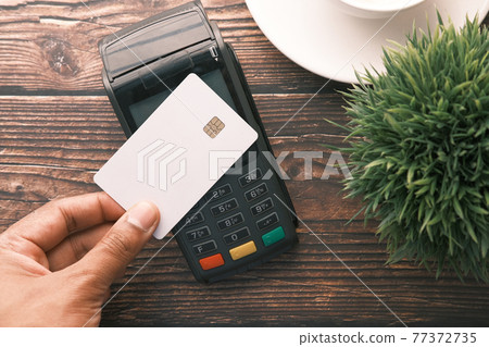 contactless payment concept with young man paying with credit card contactless payment concept with young man paying with credit card 77372735