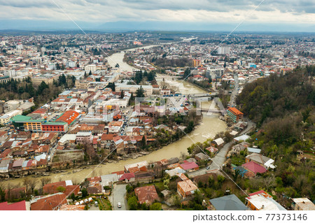 Aerial view of Kutaisi cityscape on Rioni River in springtime 77373146