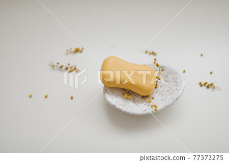 Handmade natural soap on white floral background. Soap making. Soap bars. Spa, skin care. Natural Organic spa cosmetic products on white table from above 77373275