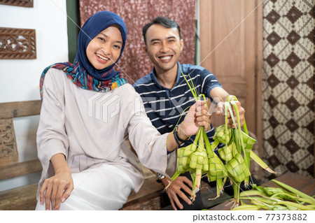 muslim family and friend making ketupat for eid fitr mubarak 77373882