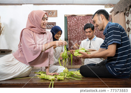 muslim family and friend making ketupat for eid fitr mubarak muslim family and friend making ketupat for eid fitr mubarak 77373883