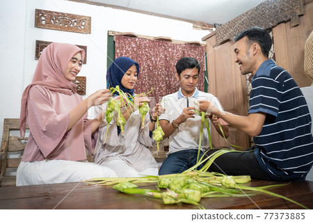 muslim family and friend making ketupat for eid fitr mubarak muslim family and friend making ketupat for eid fitr mubarak 77373885