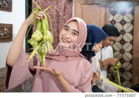 group of friend and family making ketupat together for eid fitr group of friend and family making ketupat together for eid fitr 77373887