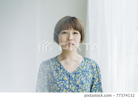Portrait of a young woman with short hair 77374132