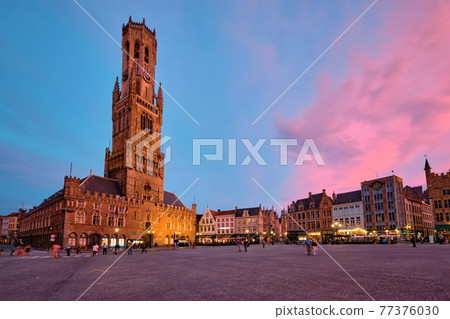 Belfry tower and Grote markt square in Bruges, Belgium on dusk in twilight 77376030