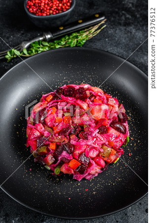 Vegetarian vinaigrette beet vegetable salad. Black background. Top view Vegetarian vinaigrette beet vegetable salad. Black background. Top view 77376512