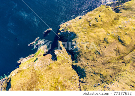 Aerial view of the beautiful coast at Malin Beg with Slieve League in the background in County Donegal, Ireland Aerial view of the beautiful coast at Malin Beg with Slieve League in the background in County Donegal, Ireland 77377652